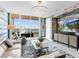 Open living room boasting floor-to-ceiling windows, a contemporary entertainment center, and stylish furnishings at 540 N Tamiami Trl # 1503, Sarasota, FL 34236