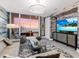 Cozy living room with modern accents, a TV, and great views from a private balcony at 540 N Tamiami Trl # 1503, Sarasota, FL 34236
