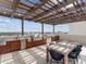 Outdoor kitchen with stainless steel grill, bar seating, and city view at 540 N Tamiami Trl # 1503, Sarasota, FL 34236