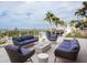 Inviting outdoor patio with comfortable seating, lush landscaping, and scenic views of the bay at 540 N Tamiami Trl # 1503, Sarasota, FL 34236
