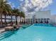 Stunning rooftop pool deck with luxury lounge chairs, cabanas, tropical palms, and relaxing views at 540 N Tamiami Trl # 1503, Sarasota, FL 34236