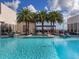Enjoy the view from the rooftop pool with palm trees and comfortable outdoor seating at 540 N Tamiami Trl # 1503, Sarasota, FL 34236