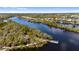 Expansive aerial view capturing the riverfront community with docks and lush greenery, perfect for waterfront living at 5515 Simonton St, Bradenton, FL 34203