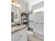 Stylish bathroom featuring a marble vanity, decorative shelving, and tub with shower at 5515 Simonton St, Bradenton, FL 34203