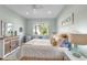 Relaxing bedroom with a dresser, large window and neutral walls at 5515 Simonton St, Bradenton, FL 34203