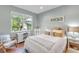 Serene bedroom with a large window overlooking lush greenery and wood flooring at 5515 Simonton St, Bradenton, FL 34203