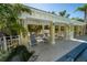 Covered lounge area with seating near the community pool, perfect for shade and relaxation at 5515 Simonton St, Bradenton, FL 34203