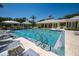 Large community pool with a fountain, surrounded by ample seating and lush landscaping at 5515 Simonton St, Bradenton, FL 34203