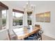 Bright dining room with rustic wood table, chandelier, and large windows with a view of the backyard at 5515 Simonton St, Bradenton, FL 34203