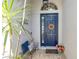 Inviting entryway featuring a stylish blue front door, decorative accents, and a cozy bench at 5515 Simonton St, Bradenton, FL 34203