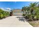 Charming home featuring a spacious two-car garage, lush landscaping, and a well-maintained driveway at 5515 Simonton St, Bradenton, FL 34203