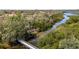Picturesque waterway with kayaks nestled amidst lush greenery, accessible via a charming wooden bridge at 5515 Simonton St, Bradenton, FL 34203