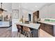 Modern kitchen with white cabinets, dark island, stainless steel appliances, and marble countertops at 5515 Simonton St, Bradenton, FL 34203