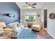 Comfortable living room with stylish decor, blue accent wall, and plenty of natural light at 5515 Simonton St, Bradenton, FL 34203