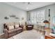 Bright living room with lots of natural light, comfortable leather furniture, and coastal themed accents at 5515 Simonton St, Bradenton, FL 34203