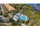 Aerial view of a luxurious community pool area with ample lounge seating and tropical landscaping at 5515 Simonton St, Bradenton, FL 34203