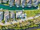 Aerial shot of canal-front houses with docks, boatlifts, and swimming pools amid lush landscaping at 556 Regatta Way, Bradenton, FL 34208