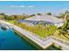 Aerial view of a waterfront property with a seawall, lush greenery, and a screened lanai at 556 Regatta Way, Bradenton, FL 34208