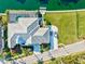 Expansive waterfront home featuring a screened pool, private dock, lush landscaping, and a spacious driveway at 556 Regatta Way, Bradenton, FL 34208