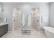 Elegant bathroom with dual walk-in showers, soaking tub, and double vanity at 556 Regatta Way, Bradenton, FL 34208