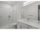Modern bathroom featuring a glass-enclosed shower with subway tile, a large mirror, and a vanity with modern fixtures at 556 Regatta Way, Bradenton, FL 34208