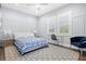 Bright bedroom with board and batten accent wall, offering comfort with windows, lamps, and tasteful decor at 556 Regatta Way, Bradenton, FL 34208