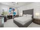 Well-lit bedroom featuring a comfortable bed, desk area, and modern decor at 556 Regatta Way, Bradenton, FL 34208