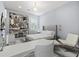 Serene bedroom with light blue walls, complemented by modern decor, a sleek desk, and a comfortable seating area at 556 Regatta Way, Bradenton, FL 34208