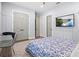 Stylish bedroom featuring a star rug, board and batten accent wall, and a wall-mounted TV at 556 Regatta Way, Bradenton, FL 34208