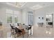 Formal dining room with ample natural light, a long dining table, and modern decor at 556 Regatta Way, Bradenton, FL 34208