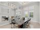 Formal dining room showcasing mirrored decor, modern lighting and large windows with natural light at 556 Regatta Way, Bradenton, FL 34208