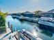 A waterfront property featuring a private dock with boatlifts on a sunny day at 556 Regatta Way, Bradenton, FL 34208