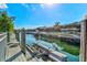 A private boat dock featuring boatlifts offers serene canal views and easy water access at 556 Regatta Way, Bradenton, FL 34208
