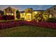 Charming front entrance with a well-manicured garden, palm tree, and double front door entrance at 556 Regatta Way, Bradenton, FL 34208