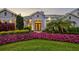 Charming front entrance with a well-manicured garden, palm tree, and double front door entrance at 556 Regatta Way, Bradenton, FL 34208