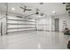 Spacious three-car garage with epoxy flooring, ceiling fans, and ample space for vehicles and storage at 556 Regatta Way, Bradenton, FL 34208