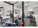 Home gym with weights, machines, punching bag and mirrored wall; attached to an epoxy-floored garage at 556 Regatta Way, Bradenton, FL 34208
