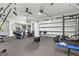 Well-equipped home gym in garage with exercise machines, weight racks, and a punching bag for training at 556 Regatta Way, Bradenton, FL 34208