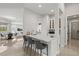 Bright kitchen featuring a sink and bar seating with views to the living and dining rooms at 556 Regatta Way, Bradenton, FL 34208