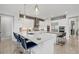 Spacious kitchen with center island, stainless steel appliances, and brick backsplash at 556 Regatta Way, Bradenton, FL 34208