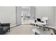 Well-lit office space with modern decor, including a tulip table and comfortable seating with a glimpse into other rooms at 556 Regatta Way, Bradenton, FL 34208