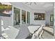 Covered patio with an outdoor dining table, a flatscreen TV, and sliding glass doors at 556 Regatta Way, Bradenton, FL 34208