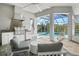 Outdoor kitchen and lounge area with built-in grill, mini-fridge and comfortable seating overlooking the pool at 556 Regatta Way, Bradenton, FL 34208