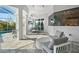 Covered outdoor patio with comfortable seating, outdoor television and view of the pool, great for entertaining at 556 Regatta Way, Bradenton, FL 34208