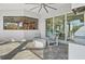 Covered outdoor patio features comfortable seating and overlooks the backyard and outdoor kitchen area at 556 Regatta Way, Bradenton, FL 34208