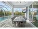 Outdoor dining area on covered patio featuring a large table, seating, and outdoor television for entertainment at 556 Regatta Way, Bradenton, FL 34208