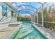 A long swimming pool in a screened enclosure with a covered patio at 556 Regatta Way, Bradenton, FL 34208