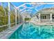 Inviting in-ground swimming pool is enclosed in a screened lanai for endless summer fun at 556 Regatta Way, Bradenton, FL 34208