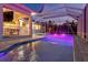 Stunning outdoor pool area with a covered patio, perfect for entertaining guests in the evening at 556 Regatta Way, Bradenton, FL 34208