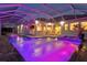 Stunning outdoor pool area with a covered patio, perfect for entertaining guests in the evening at 556 Regatta Way, Bradenton, FL 34208